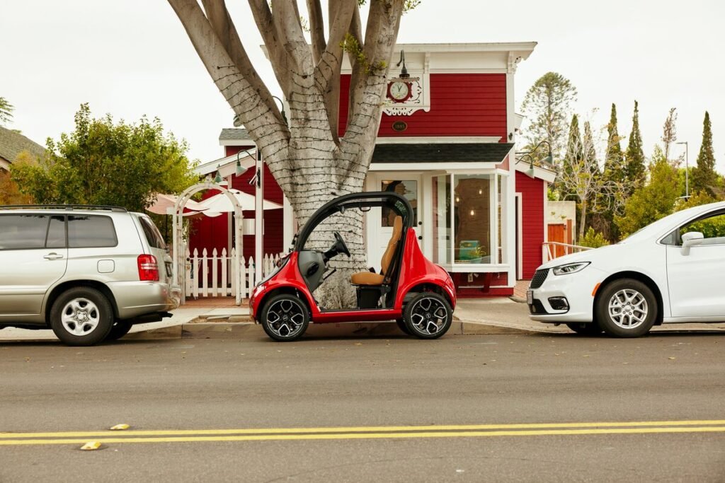 GEM-e2-MY24-sunset-red-lifestyle-premium-seats-beechwood-tan-panoramic-skyroof-parked-1200x800-9b9f185-1-1024x683 Discover the Affordable GEM Electric Car Price